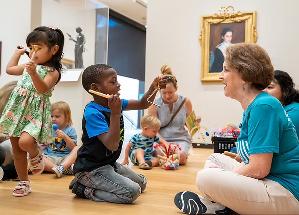 AFW_ACMAA_6_7_2023 A diverse group of young children at Amon Carter Museum playing instruments like the triangle.